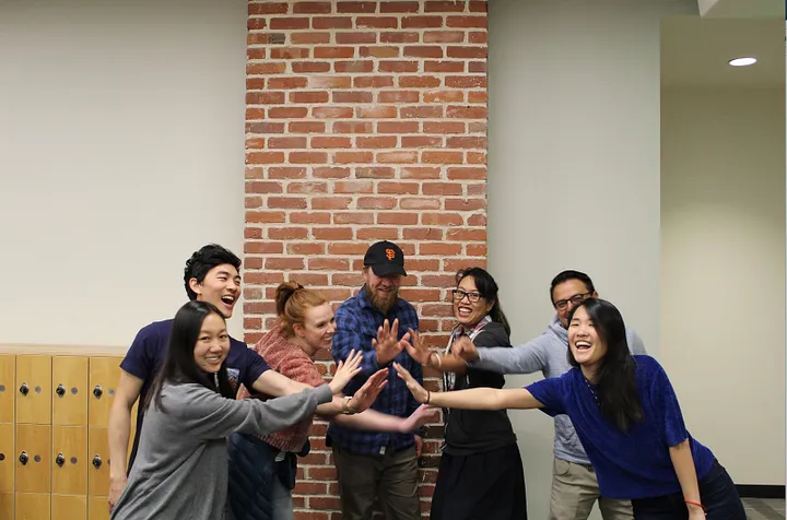 Delta Analytics team celebrating project completion